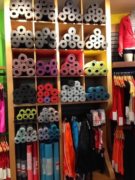 A vibrant display of sports equipment and apparel in a sporting goods store, highlighting the variety and innovation in products catering to amateur athletes. The image should convey the idea of a thriving industry driven by the increasing participation in sports.