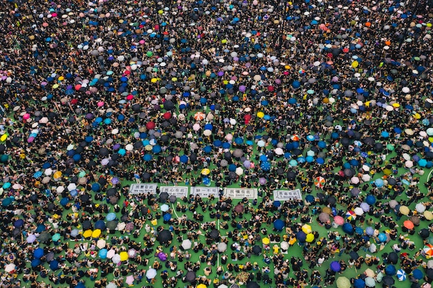 A bird's-eye view of a modern football stadium, filled with fans cheering during a game. The vibrant colors of the teams and the energy of the crowd are palpable. The picture captures the excitement and passion of sports.