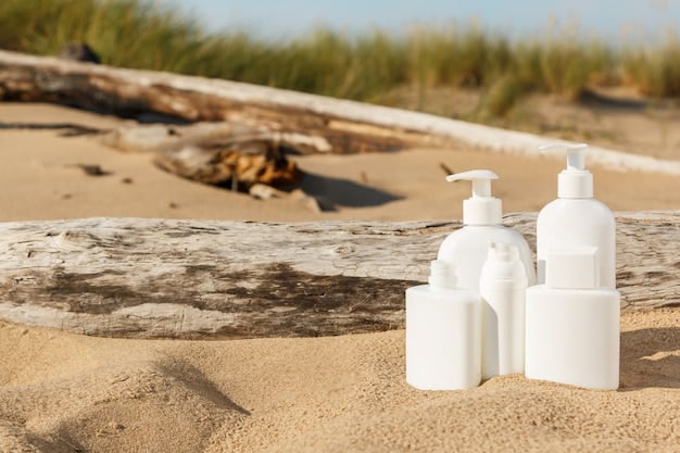 A close-up shot of different types of sunscreen bottles on a sandy beach, with clear blue water in the background. The focus is on the labels and textures of the sunscreens, highlighting their diverse properties.