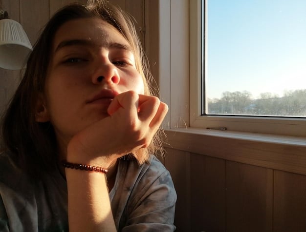 A close-up shot of a person coughing indoors with rays of sunlight casting shadows from a window over the individual's face, emphasizing the vulnerability to respiratory issues.