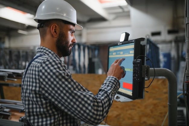 A close-up of a sensor attached to a large industrial machine, displaying real-time data on a small screen. The background shows blurred factory activity, emphasizing the sensor's role in monitoring machine performance.