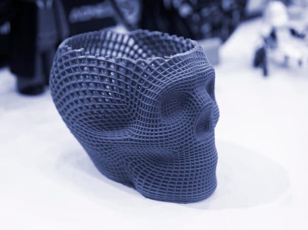 A close-up shot of a variety of intricately designed 3D-printed parts displayed on a table. The parts vary in color, shape, and size, showcasing the flexibility and precision of 3D printing. The lighting highlights the details of each piece, demonstrating the complexity and customization achievable with this technology.