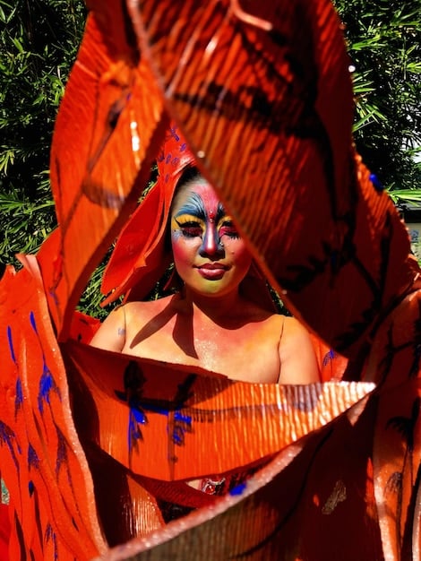 An indigenous tribe in the Amazon rainforest performing a traditional dance, with colorful body paint and intricate headdresses, showcasing their rich cultural heritage and connection to nature.