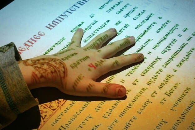 A close-up photograph of a dictionary page highlighting words of Indigenous origin, with annotations explaining their meanings and origins.