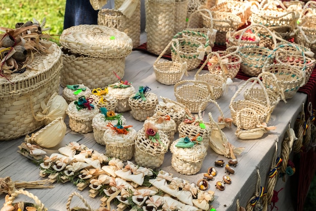 A panoramic shot of a vibrant Indigenous market, showcasing various handcrafted items such as baskets, pottery, and woven textiles, with Indigenous artisans interacting with customers.