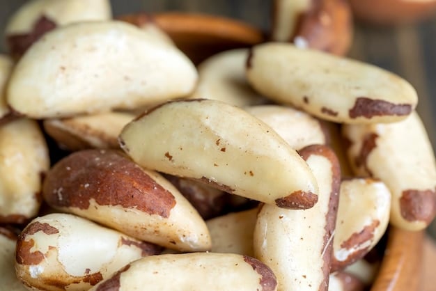 A close-up of a pile of Brazil nuts, showcasing their rough, textured shells and creamy white interiors. The nuts are arranged on a rustic wooden surface, creating a natural and organic feel. The lighting is warm, enhancing the rich colors and textures of the nuts.