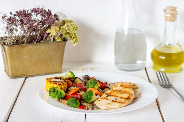 A balanced and healthy meal consisting of grilled chicken, steamed vegetables, and a small portion of quinoa displayed on a dinner table, emphasizing the importance of diet for better sleep.
