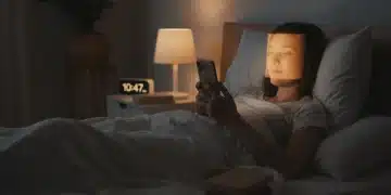 Person using phone with blue light filter for better sleep